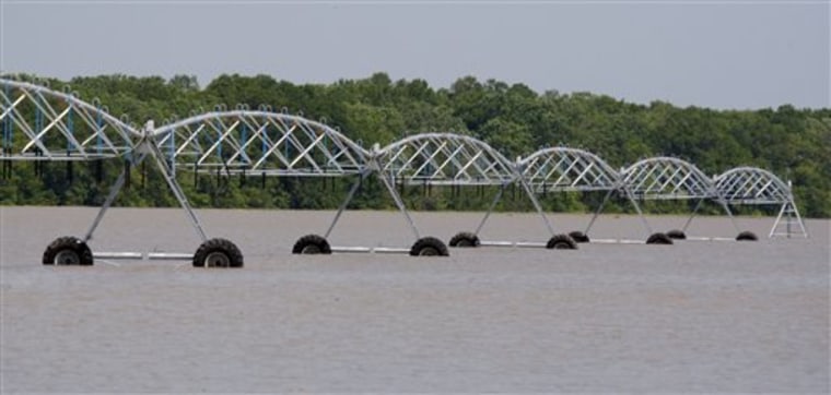 In a May 12, 2011 photo, circle irrigation system looks like a bridge span from the distance on the underwater soybean crop of Brett Robinson along River Road, north of Yazoo City, Miss. Thousands of acres of corn, wheat, soybean and cotton crops are now underwater as the tributaries are backing up from flooding along the Mississippi River. (AP Photo/Rogelio V. Solis)